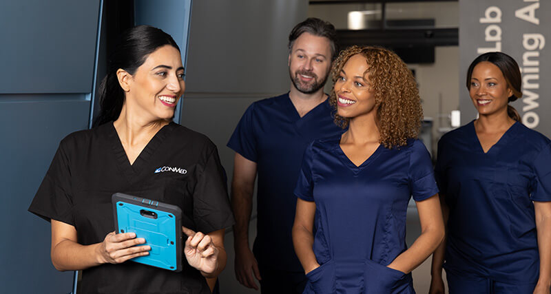 Vier medizinische Fachkräfte gehen einen Flur entlang.